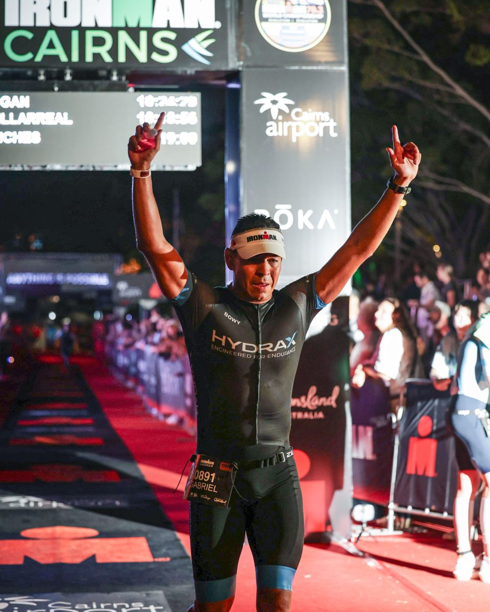 Gabriel Villarreal crossing the finish line at Ironman Cairns